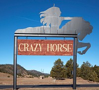                         Entrance sign to the grounds of the slowly developing but (as of 2021) far from complete Crazy Horse Memorial, a monumental sculpture of the 18th-Century Oglala band leader Crazy Horse, near Custer, South Dakota                        
