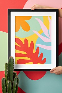 Photo frame mockup, hand decorating wall psd