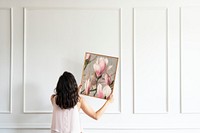 Photo frame mockup, woman decorating wall psd