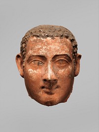 Mask of a man with short curly hair and long sideburns, Roman Period (A.D. late 1st century probably)