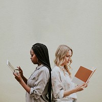 Diverse women reading a book and using a tablet