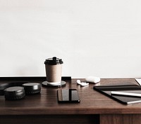 Coffee cup and a digital tablet on a wooden desk