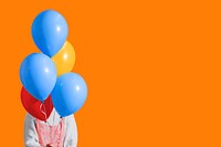 Party orange background, woman holding balloons