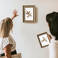 Photo frame mockups, interior designers decorating wall psd