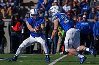 From left, U.S. Air Force Cadet 4th Class Nate Romine, a freshman quarterback for the Air Force Academy Falcons, hands the ball to Cadet 1st Class Anthony LaCoste, a senior running back, during the first quarter of a football game against the Army Black Knights at Falcon Stadium in Colorado Springs, Colo., Nov. 2, 2013.