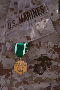 U.S. Marine Corps Master Sgt. Jonathan Balbuena, an operations and training chief with Combat Logistics Regiment 2, Regional Command (Southwest), receives a Navy and Marine Corps Commendation medal in recognition of his performance prior to his deployment to Camp Leatherneck in Helmand province, Afghanistan, Sept. 27, 2013.