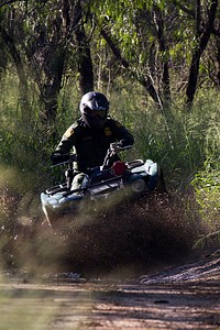 Border Patrol Agent Patrols South Texas Border on an All Terrain Vehicle (ATV)