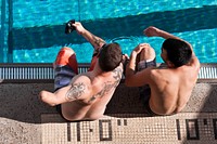 U.S. Air Force Tech. Sgt. Leonard Anderson and Staff Sgt. Daniel Crane review swimming techniques together during the Wounded Warrior Pacific Invitational swim meet Jan. 9, 2014, at 'Iolani School's Dillingham Pool in Honolulu.