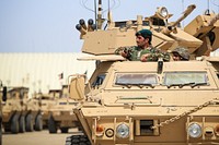 An Afghan Nation Army soldier stands in an M1117 Guardian Armored Security Vehicle during an indirect fire response drill at Camp Shorabak, Helmand province, Afghanistan, March 19, 2014.