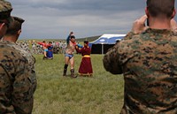 U.S. and foreign service members participating in exercise Khaan Quest 2014 watch Mongolians wrestle during a mini-Naadam festival June 27, 2014, at the Five Hills Training Area in Mongolia.