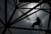U.S. Air Force Senior Airman Emma Duff, a broadcaster with American Forces Network, rappels through beams during tower rescue training at Osan Air Base, South Korea, Aug. 27, 2014.