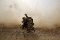 U.S. Marine Corps Cpl. Daniel Hopping, an assaultman with Weapons Company, 1st Battalion, 7th Marine Regiment, shields himself from dust being kicked up from a CH-53E Super Stallion helicopter lifting off April 28, 2014, during a mission in Helmand province, Afghanistan.