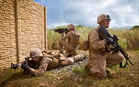 U.S. Marines assigned to India Company, 3rd Battalion, 3rd Marine Regiment, provide security outside of a compound wall during a search and rescue mission at the Boondocker Training Area at Marine Corps Base Hawaii May 29th, 2014.