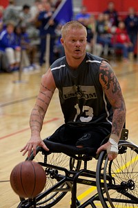 Retired U.S. Marine Corps Cpl. Justin Gaertner plays with the U.S. Special Operations Command wheelchair basketball team against the Air Force team during the 2014 Warrior Games in Colorado Springs, Colo., Sept. 30, 2014.