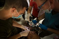 A U.S. Navy hospital corpsman, left, attached to the 3rd Medical Battalion and Filipino volunteers extract a tooth during a community health engagement at San Rafael High School in Palawan province, Philippines, Sept. 26, 2014, prior to Amphibious Landing Exercise (PHIBLEX) 15.