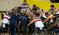 Members of the U.S. wheelchair basketball team up during halftime during a match against the Dane team in the Invictus Games at the Copper Box Arena at Queen Elizabeth Olympic Park in London Sept. 13, 2014.