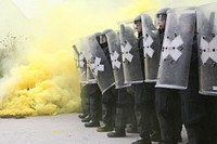 German soldiers form a crash line while conducting riot control training during the Kosovo Force (KFOR) 19 Mission Rehearsal Exercise at the Joint Multinational Readiness Center in Hohenfels, Germany, Oct. 12, 2014.