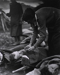 U.S. Army Evacuation Hospital Nos. 6 & 7, Souilly, France, Red Cross worker Miss Anna Rochester, of the Smith College Unit, feeding wounded soldier through a tube. Original public domain image from Flickr