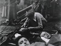 U.S. Army Evacuation Hospital Nos. 6 & 7, Souilly, France, Red Cross worker Miss Anna Rochester, of the Smith College Unit, ministering to the wounded. Original public domain image from Flickr