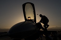 U.S. Air Force Capt. Doug Mayo, 555th Expeditionary Fighter Squadron, enters an F-16 Fighting Falcon aircraft before conducting a preflight inspection with Staff Sgt. William Harris, 455th Expeditionary Maintenance Squadron crew chief, at Bagram Air Field, Afghanistan, June 8, 2015.