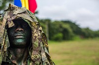 A scout sniper with the Infantería de Marina de Colombia poses for a photo during a demonstration at the Marine Infantry Training Base in Coveñas, Colombia at the Marine Leaders of the Americas Conference, Aug. 27, 2015.