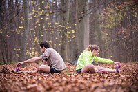 At the end of the penultimate day of the event, two runners stretch off near Brussels in Belgium.