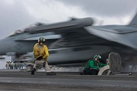 U.S. Navy Aviation Boatswain's Mate (Equipment) Airman Hailey Barela, right, and Lt. Cmdr. Robert Maul, from Springfield, New Jersey, signal the launch of an F/A-18E Super Hornet, assigned to Strike Fighter Squadron (VFA) 195, on the flight deck aboard the Navy's forward-deployed aircraft carrier, USS Ronald Reagan (CVN 76) during the Carrier Air Wing Five fly-off in the Pacific Ocean in waters south of Japan Nov. 28, 2017.