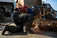 U.S. Coast Guard Seaman Conor Magill, a buoy deck crewmember assigned to the Coast Guard Cutter Katherine Walker, cuts chain with a torch aboard the Coast Guard Cutter Katherine Walker while transiting the New York Harbor, March 8, 2016.