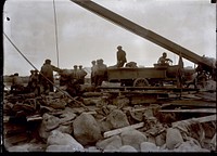 Soldiers standing amongst debris. Original public domain image from Flickr