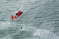 A U.S. Coast Guard aviation survival technician, rescue swimmer, is hoisted out of the water by the crew of MH-65 Dolphin helicopter from Air Station Port Angeles, during a training exercise off the coast of Washington, Jan. 26, 2018.