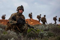 U.S. Marine Corps Lance Cpl. Eric J. Radtke, a rifleman, scans the area outside of an objective during Exercise Hamel at Cultana Training Area, South Australia, Australia, July 7, 2016.