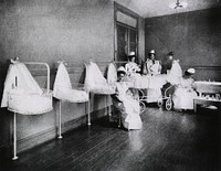 Hospitals - Pediatrics: Nurses holding infants at the New York infirmary for women and children (1913). Original public domain image from Flickr