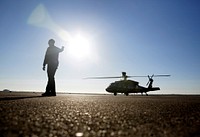 A ground support officer signals for a U.S. Customs and Border Protection Black Hawk helicopter to hold in place at Ellington Field Joint Reserve Base as they prepare for a press event in advance of Super Bowl LI in Houston, Texas, Jan 31, 2017.