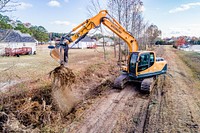 Stormwater ImprovementsGreenville Public Works clearing an overgrown stormwater ditch to reduce flooding.