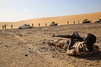 A Chadian Army Soldier who is a simulated casualty awaits medical assistance during a simulated assault in Faya-Largeau, Chad Mar. 3, 2017 as part of Flintlock 17.