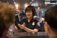 Officers with the U.S. Customs and Border Protection, Office of Field Operations, process international arrivals of passenger flights at Boston Logan International Airport June 21, 2017 in Boston, Mass. U.S. Customs and Border Protection photo by Glenn Fawcett.