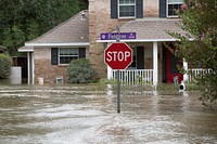 A stop sign stands above a flooded street in a suburb of Houston, Texas, as U.S Border Patrol riverine agents evacuate residents in the flooded areas in the aftermath of Hurricane Harvey August 30, 2017.