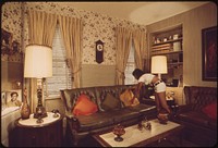 Sandra Bruno Straightens a Pillow in the Immaculate Living Room of Her Family's Home at 39 Neptune Road. Original public domain image from Flickr