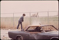 Logan Airport Area. Neighborhood Boys Play Rough with an Abandoned Car behind the Wood Island Station of the MBTA. Original public domain image from Flickr