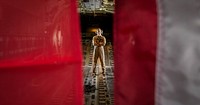 U.S. Marine Corps Cpl. Jordan Lamb, a crewmaster with Marine Aerial Refueler Transport Squadron (VMGR) 352, Special Purpose Marine Air-Ground Task Force-Crisis Response-Central Command (SPMAGTF-CR-CC), poses in between the U.S. Marine Corps flag and U.S. American flag in a KC-130J Super Hercules while forward deployed in the Middle East, Sept. 3, 2017.