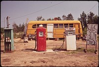 Old gas station with a bus. Original public domain image from Flickr