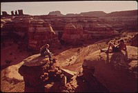 Hikers Terry Mcgaw and Glen Denny Enjoy a View of the Maze from the Top of a Ridge Separating Two Canyons. The Maze, a Wild and Rugged Region in the Heart of the Canyonlands, Has No Footpaths, and Hikers Enter by Means of Ropes Or Steps Cut in the Rocks. Original public domain image from Flickr