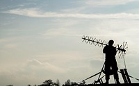 U.S. Air Force Airman 1st Class Colin Martin, a radio frequency transport system apprentice assigned to the 5th Communications Squadron, adjusts an antenna in support of strategic bomber deployment at RAF Fairford, England, Jan. 10, 2018.