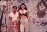 Two Latin Girls Pose in Front of a Wall of Graffiti in Lynch Park in Brooklyn, New York City. This Project Is a Portrait of the Inner City Environment.