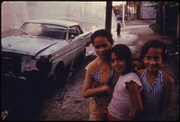 Three Young Girls on Bond Street in Brooklyn, New York City the Inner City Today Is an Absolute Contradiction to the Main Stream America of Gas Stations, Expressways, Shopping Centers and Tract Homes.