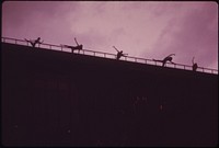 The "Celebrations" Group of Marilyn Woods Rehearses Dance on the Roof of the Fifth Third Bank Building Overlooking Fountain Square. They Are Using the Safety Rail as a Dance Bar 08/1973. Photographer: Hubbard, Tom. Original public domain image from Flickr