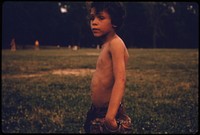 Puerto Rican Boy Playing Ball in Hiland Park of Brooklyn New York City. The Inner City Today Is an Absolute Contradiction to the Main Stream America of Gas Stations, Expressways, Shopping Centers and Tract Homes.