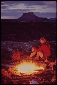 Camping in the Maze, a Remote and Rugged Region in the Heart of the Canyonlands. Because It Seldom Rains, Tents Are Not Necessary. Firewood Is Dry and Plentiful. Ekker Butte Rises in the Background, 05/1972. Original public domain image from Flickr
