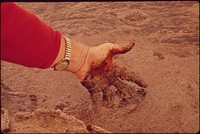 Man touching crude oil in San Juan River, 10/1972. Original public domain image from Flickr