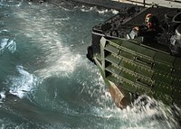 A U.S. Marine attached to the 31st Marine Expeditionary Unit embarked aboard the forward-deployed amphibious transport dock USS Denver (LPD 9) waits for the last of 15 amphibious assault vehicles to enter Denver?s well deck while under way in the Pacific Ocean Sept. 28, 2009.